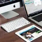 Different technologies on a table, laptop, tablet, desktop computer