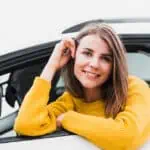 happy woman in a company car