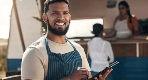 Sole trader holding-= a tablet